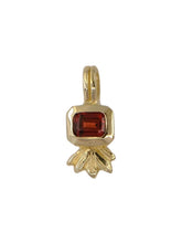 Load image into Gallery viewer, A gold-colored pendant featuring a hand-carved lotus flower with a red emerald-cut garnet center.