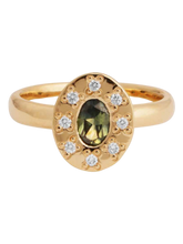 Load image into Gallery viewer, A gold ring featuring a central sapphire gemstone surrounded by smaller diamonds, with a hand-engraved pattern beneath the setting.