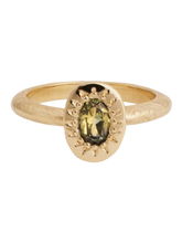 Load image into Gallery viewer, A gold band ring with a central stone, possibly a sapphire, set in a mounting with intricate details.