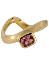 Load image into Gallery viewer, A gold band ring with a curved design, featuring a small emerald-cut sapphire in the center.