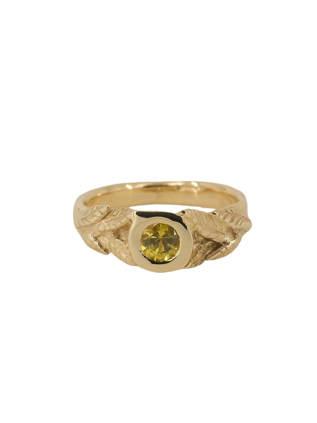 A yellow gold ring with a round natural diamond and hand-carved leaf detailing on a plain background.