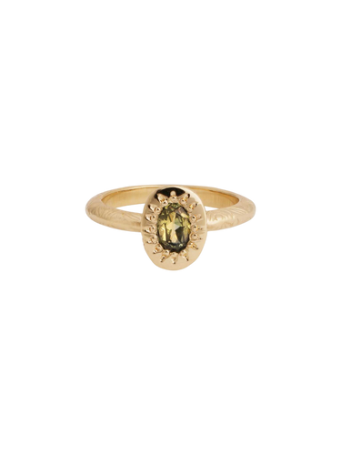 A gold band ring with a central stone, possibly a sapphire, set in a mounting with intricate details.
