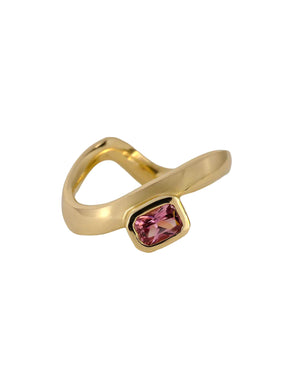 A gold band ring with a curved design, featuring a small emerald-cut sapphire in the center.