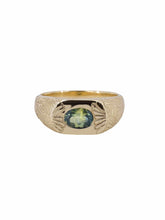 Load image into Gallery viewer, A gold band ring with a central natural Australian parti sapphire and hand-engraved ginkgo leaf design extending onto the band.
