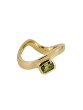 Load image into Gallery viewer, A gold band ring with a green sapphire gemstone set in the center.
